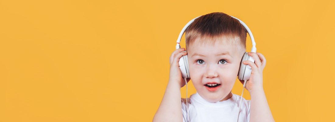 kid listening a music in a headphones