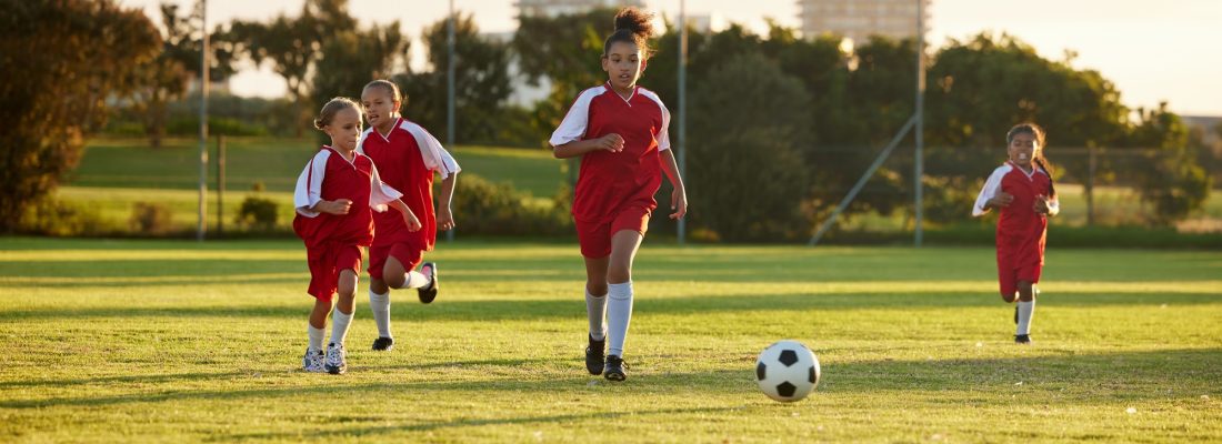 Sports, fitness and soccer training by girl team playing on grass field, teamwork during football g