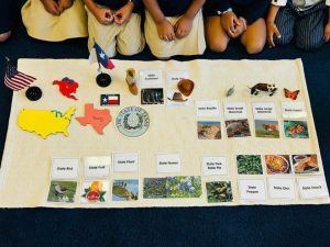 Children are exploring maps and images to enhance their learning experience.