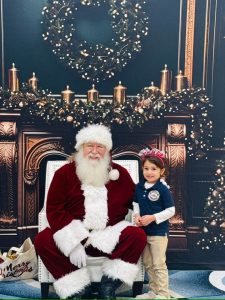 Santa Claus is having a great time celebrating Christmas with the kid at Pinnacle Montessori of Alamo ranch.