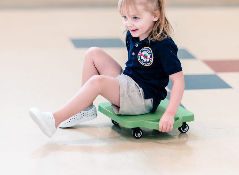 A student at Pinnacle Montessori of Alliance is enjoying an indoor activity.