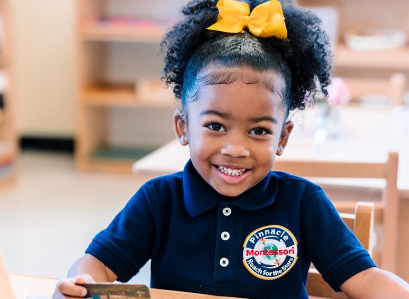 A North American student deeply engaged in a hands-on Montessori activity at Pinnacle Montessori of Forney,