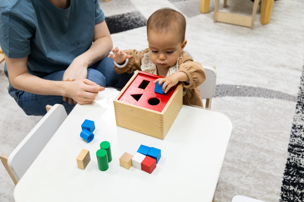 toddler with Montessori toys