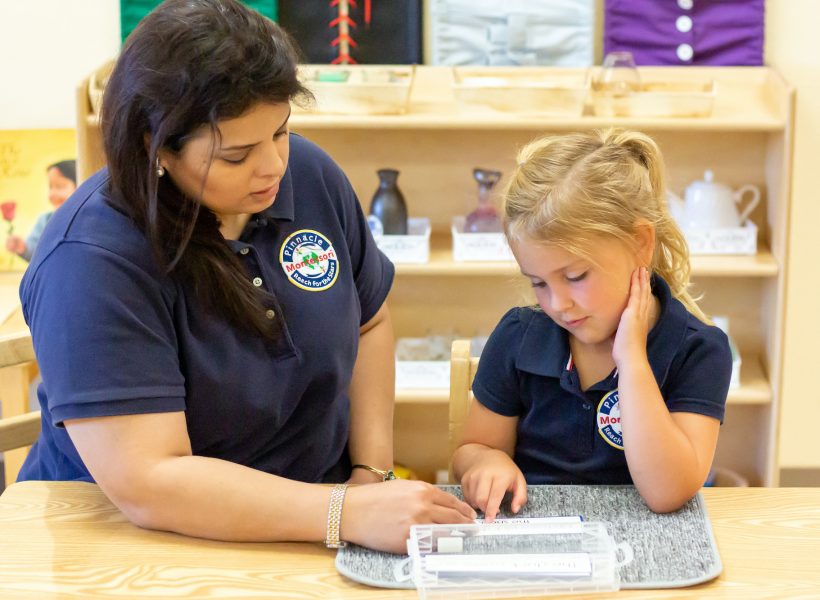 Pinnacle Montessori Educator Assisting Girl Students