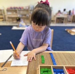A young learner at Pinnacle Montessori of Schertz is participating in hands-on activities.